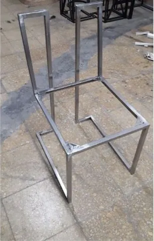 Bare mild steel bar stool frame before upholstery, showing the cantilever side profile