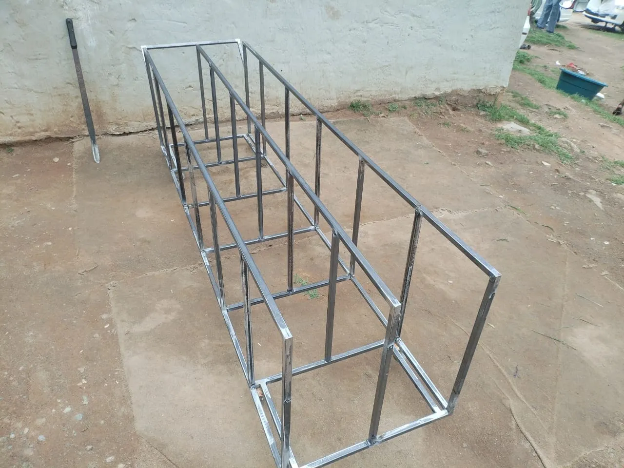 Storage rack in bare welded steel before painting, showing the dividers and the welded base frame